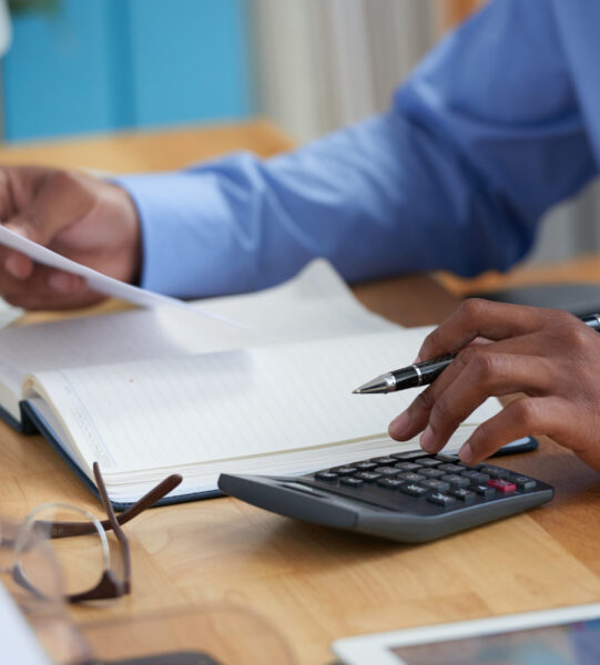 Close-up image of financial managers working with reports